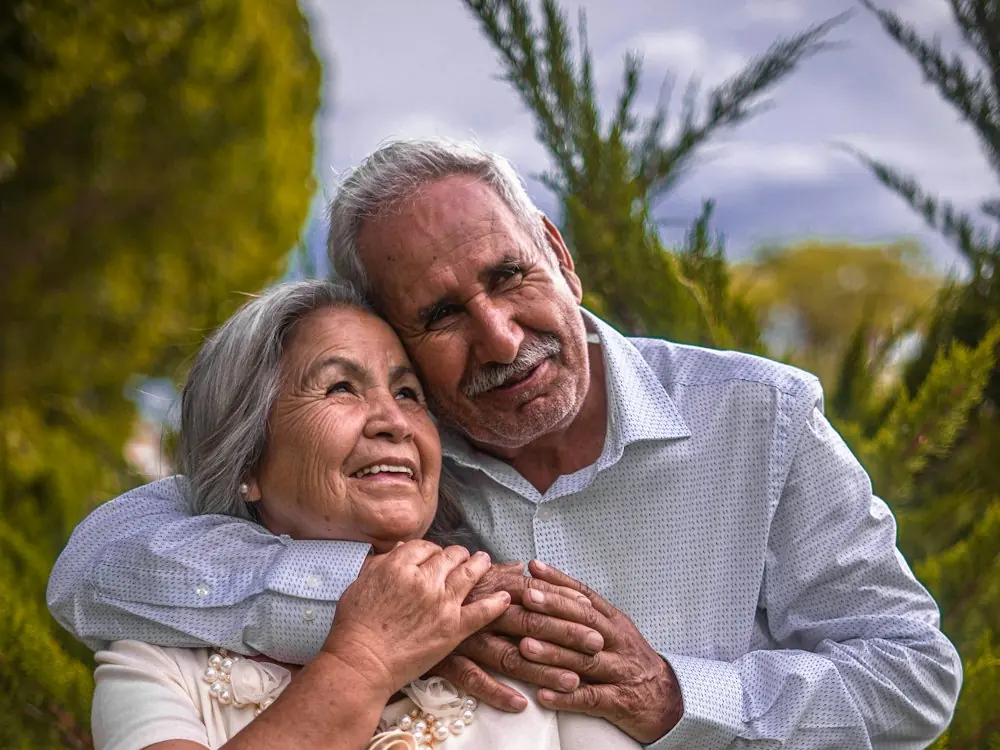 A happy senior Indian couple embracing outdoors