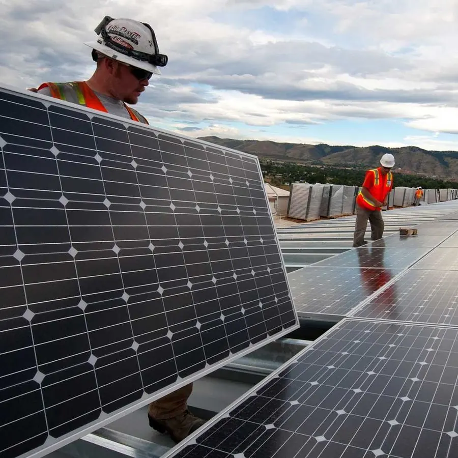 Solar installers fitting panels on a rooftop