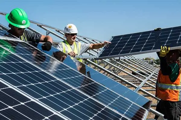 Installation crew mounting panels on a large structure