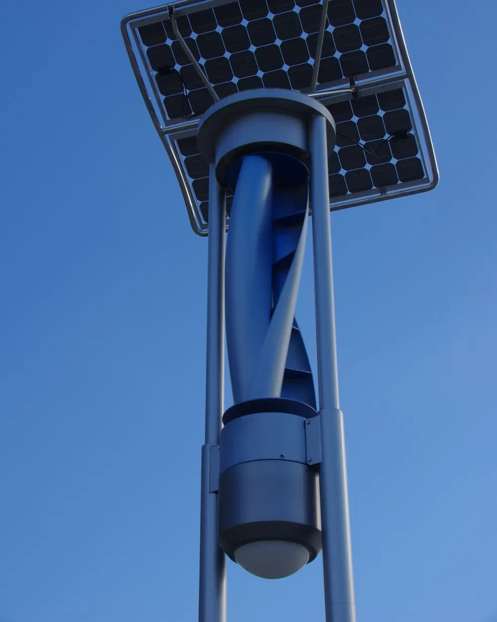 Vertical-axis wind turbine with a solar panel on the same pole